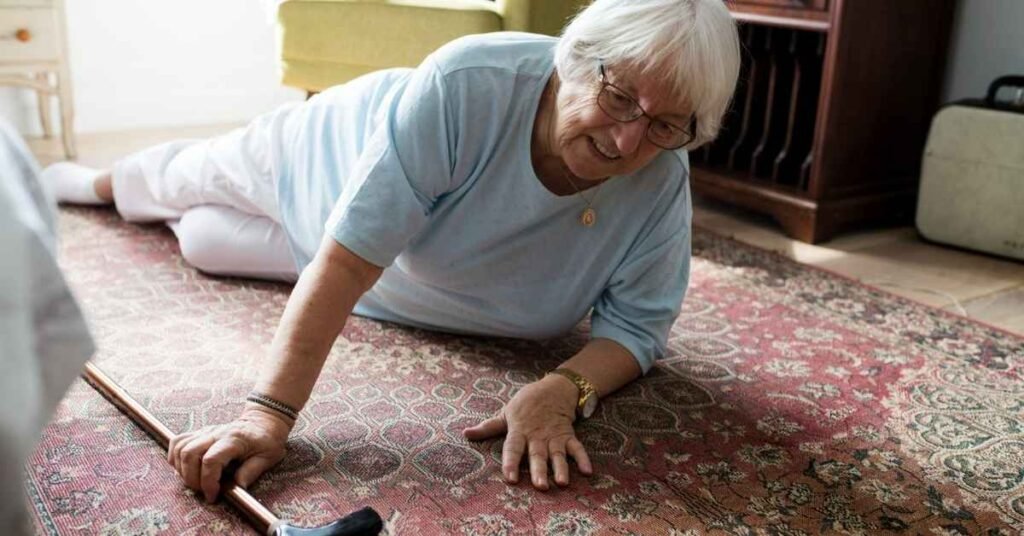 Senior woman on the floor reaching for her cane at home, highlighting the need for effective Fall Prevention Strategies for older adults.