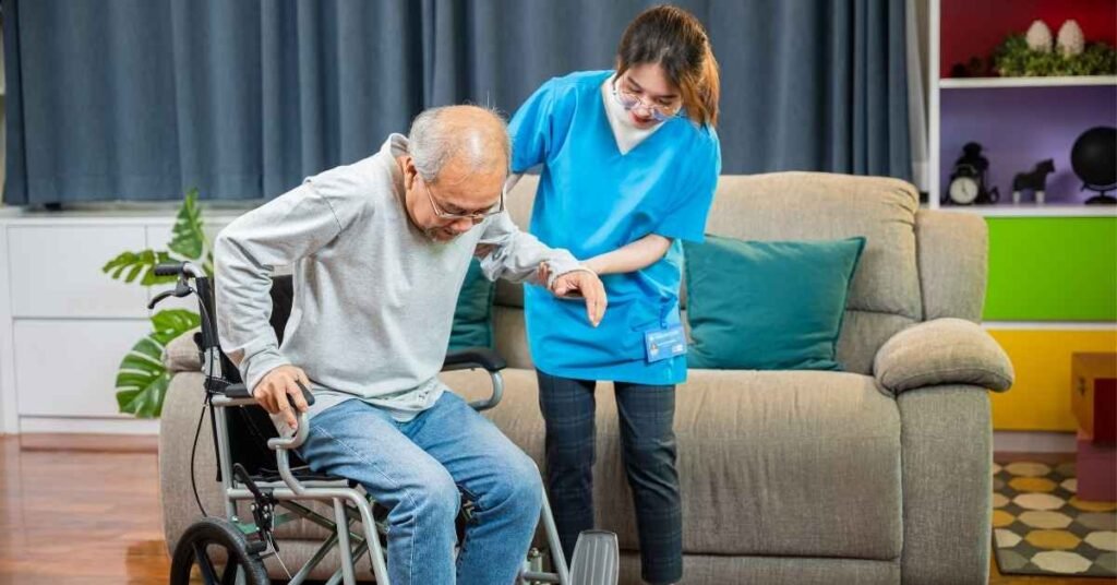 Caregiver providing Respite Care at home as she assists an elderly man moving safely from a wheelchair.