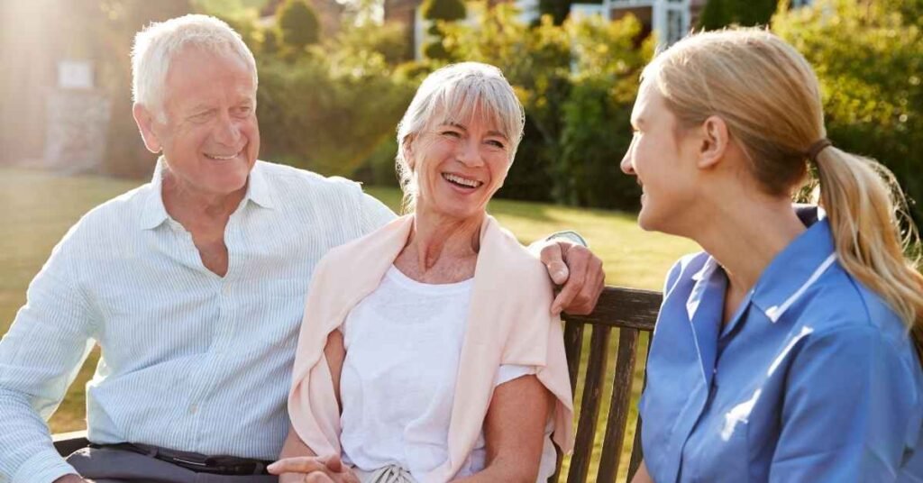 Professional Respite Care provider supporting elderly couple during outdoor companionship in Michigan.
