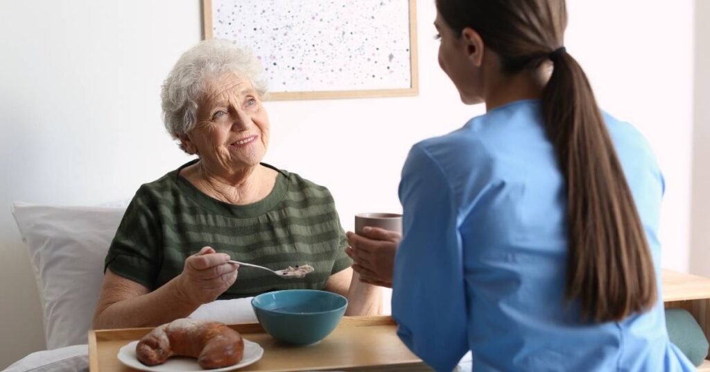Caregiver assisting a Michigan senior with meal planning and nutrition support at home, providing healthy food and hydration during in-home care.